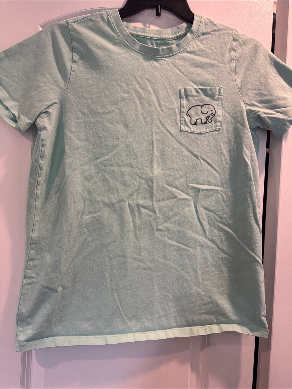 ivory ella Mint Green tee w logo front pockets and field hockey graphic on back.